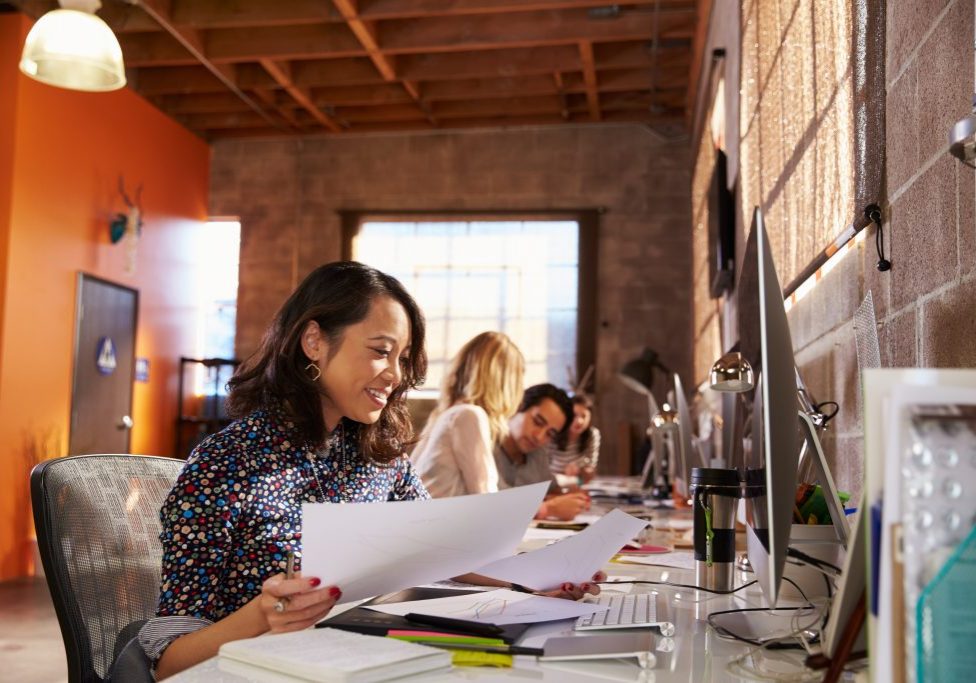 Team,Of,Designers,Working,At,Desks,In,Modern,Office improving workplace culture