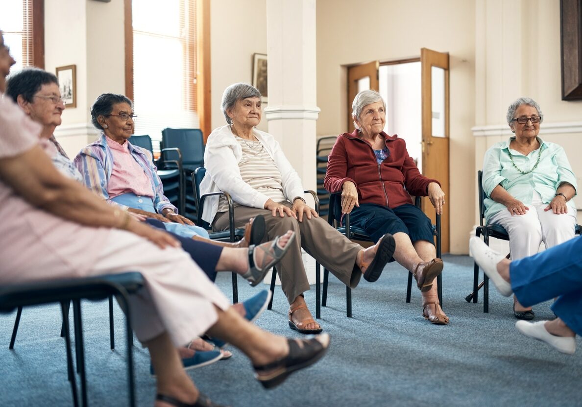 Cropped shot of a female fitness instructor taking a class in an old age home